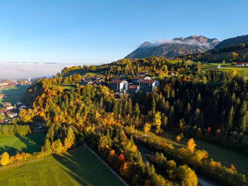 The AllgäuSternHotel in Sonthofen during autumn time in front of the Grünten mountain.