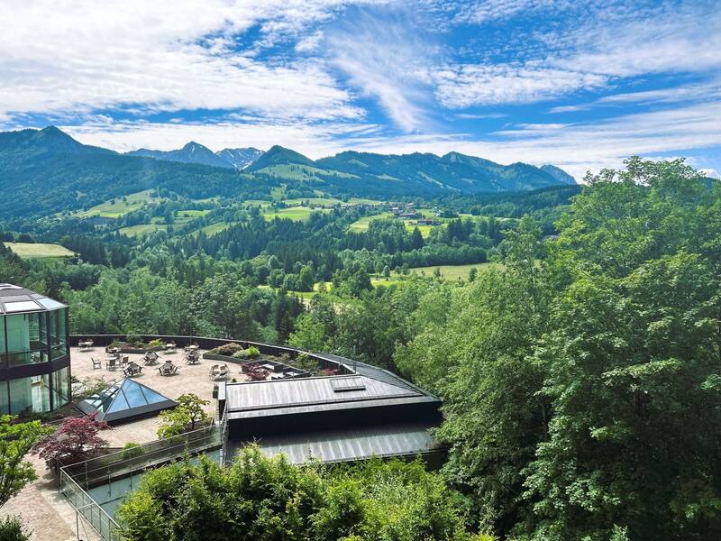 Die Sonnenterrasse im AllgäuSternHotel mit Blick auf die umliegende Sommerlandschaft.